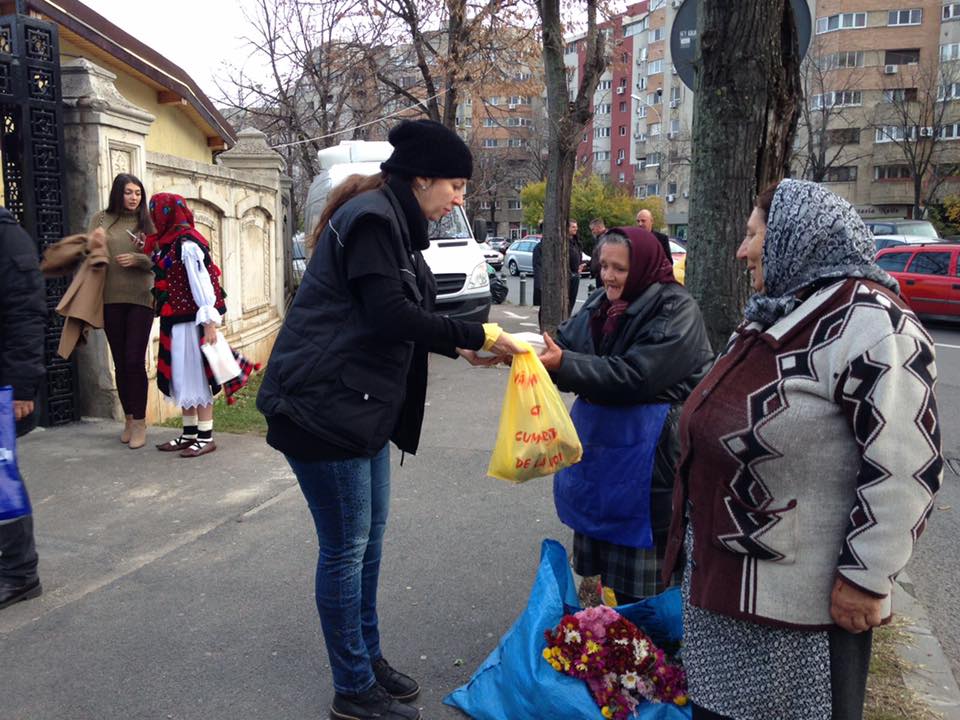 Volunteers cook and share food to poor people on the streets of Bucharest